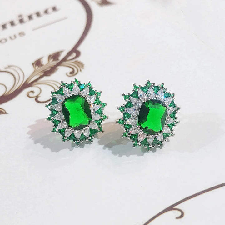 طقم مجوهرات نسائي من الزمرد والياقوت - قلادة، خاتم، وأقراط